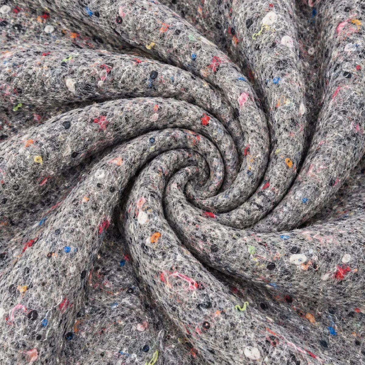 Tela cobija para embalaje gris con fibras multicolor, dispuesta en remolino.